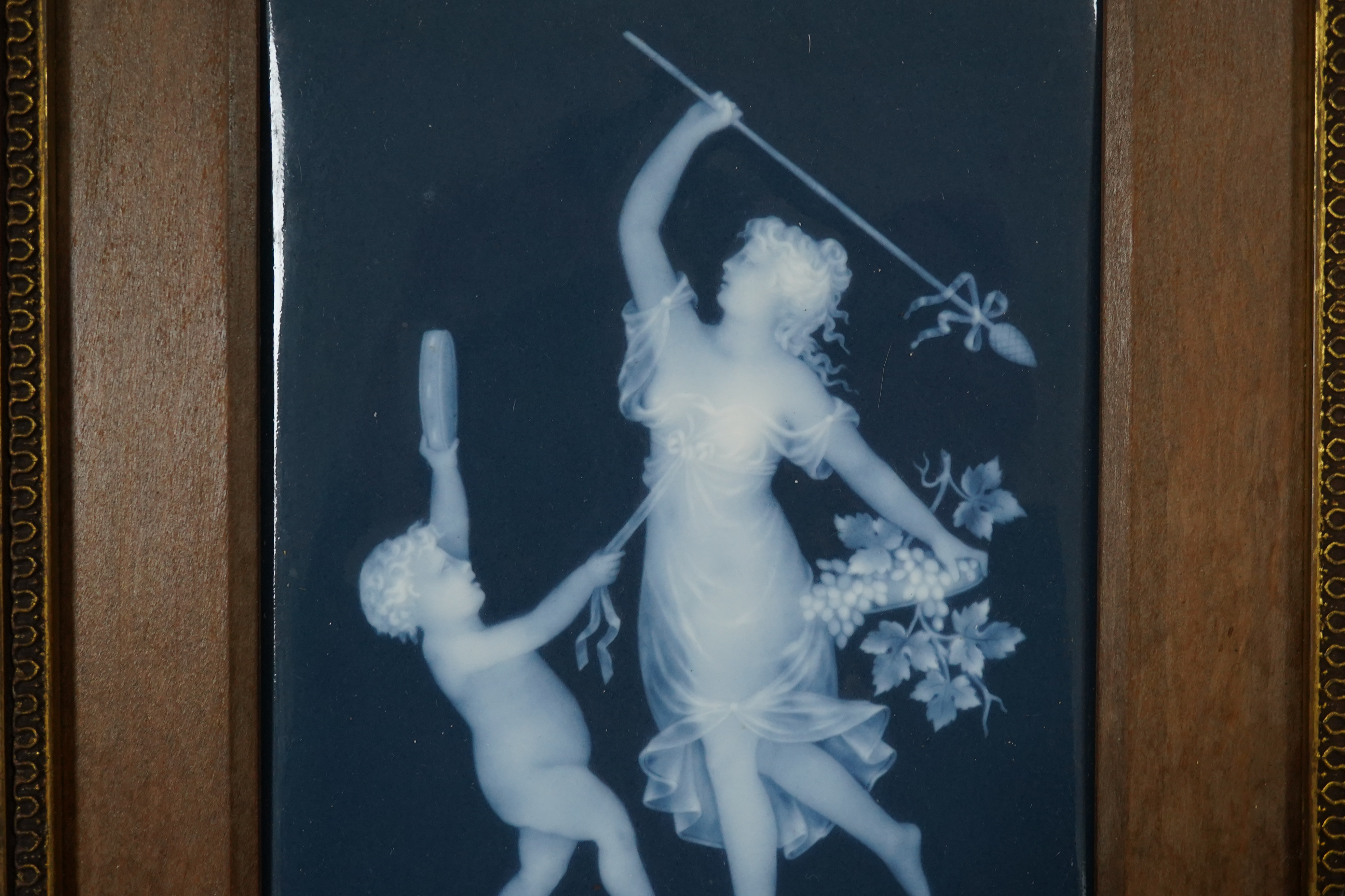 A Limoges pate-sur pate plaque of a musical putti and a dancing lady, signed. 17.5cm x 13cm. Condition - plaque good, frame slightly scratched